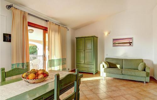 a living room with a table with a bowl of fruit at Mono 2 in Badesi