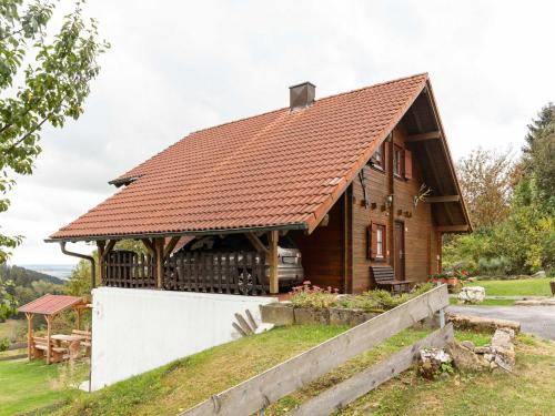 a small wooden house with a brown roof at Wooden holiday home in Hinterrod with sauna in Einsiedel