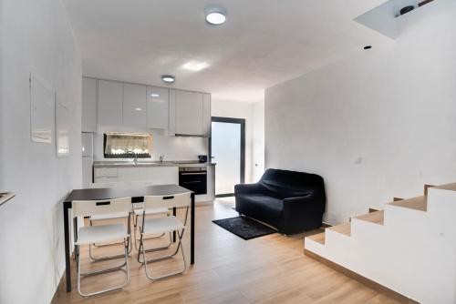 a kitchen and dining room with a table and chairs at Areias Village in Vale de Cambra