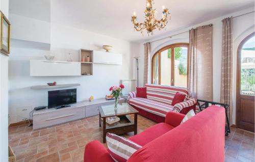 a living room with two red couches and a tv at Villino Le Rose in Dicomano
