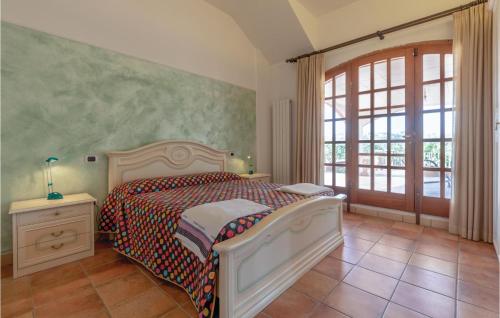 a bedroom with a bed and a large window at Nice Apartment In Perugia -pg- With Outdoor Swimming Pool in Ponte Felcino