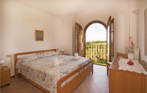 a bedroom with a bed and a large window at Casale Del Borgo 7 in Querce