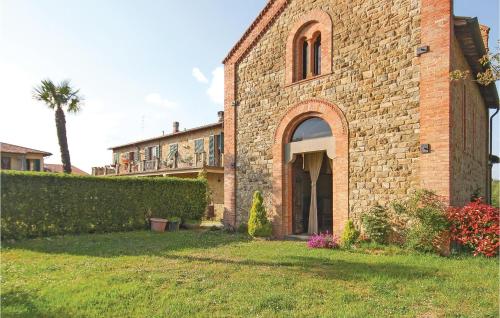 a brick building with an archway in a yard at Casale Del Borgo 7 in Querce