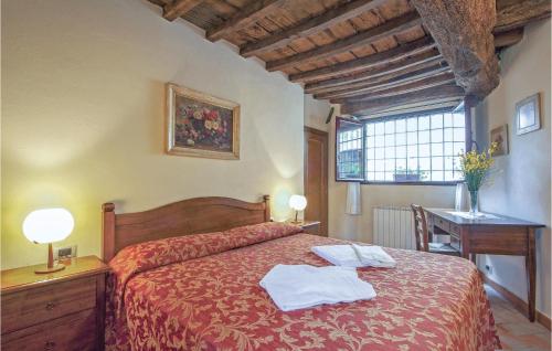 a bedroom with a bed with two towels on it at Sangiovese 1 in San Donato in Poggio