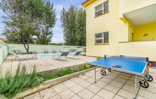 a blue ping pong table in front of a house at 5 Bedroom Amazing Home In Torvaianica in Torvaianica