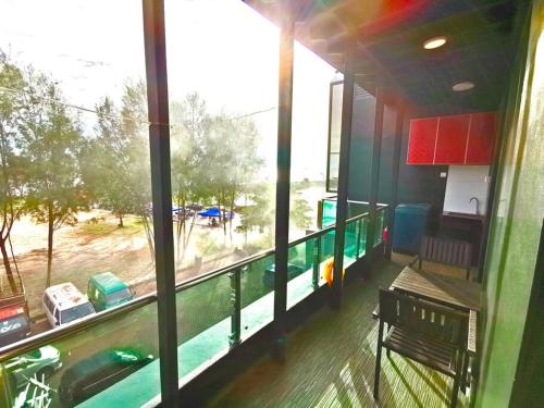 a balcony with a large window with a view of a field at Galaxy House with seaview balcony- JB PONTIAN in Pontian Kecil