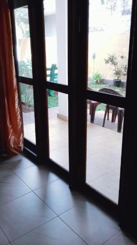 an open glass door with a view of a patio at Villa DeLorenta in Anuradhapura
