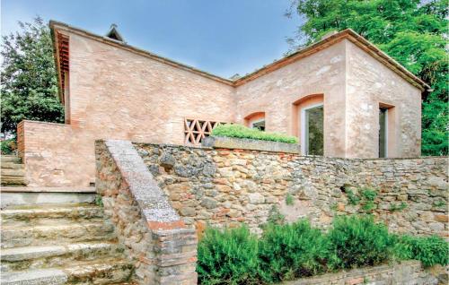 a stone house with a stone wall and stairs at Sanlucchese 3 in Poggibonsi