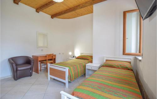 a bedroom with two beds and a desk and a chair at Villa Mare in Ioppolo
