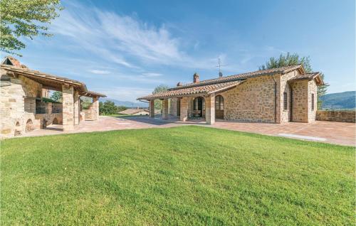 an exterior view of a stone house with a large yard at Il Vigneto in Brufa