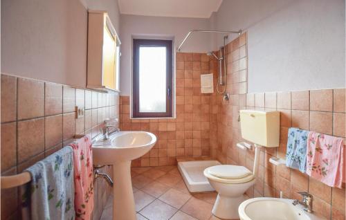 a bathroom with a toilet and a sink at Matteo Appartamento in Ovile la Marinella