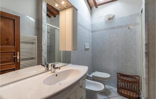 a white bathroom with a sink and a toilet at Borgo Lugnano in Lugnano