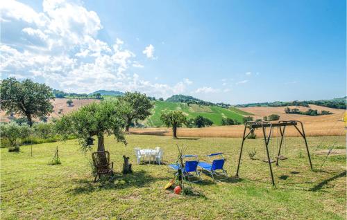 a group of chairs and a swing in a field at Casa Beatrice in San Lorenzo in Campo