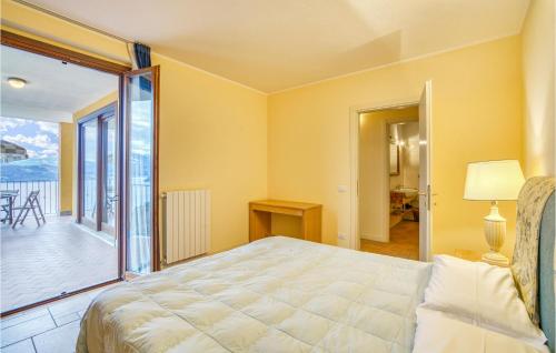 a bedroom with a bed and a balcony at Vigneto Due - Bilo 22 in Oggebbio