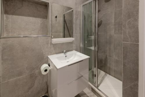 une salle de bain avec toilettes, lavabo et douche dans l'établissement APPARTEMENT CONTEMPORAIN RÉPUBLIQUE - TEMPLE, à Paris