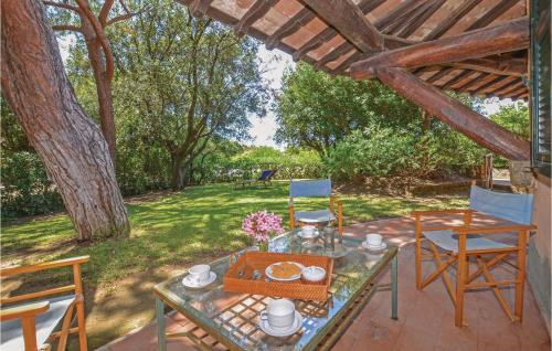 a table and chairs on a patio in a yard at Casa Pescaia in Castiglione della Pescaia