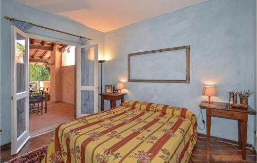 a bedroom with a bed and a table with lamps at Casa Pescaia in Castiglione della Pescaia