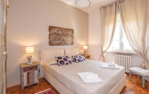 a bedroom with a bed with purple pillows and a window at Casa Catullo in Desenzano del Garda