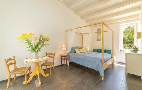 a bedroom with a bed and a table and chairs at Biancolilla in Alia