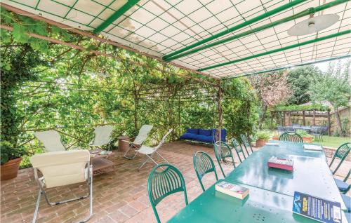 an outdoor patio with a pergola with a table and chairs at La Canonica in Piegaro