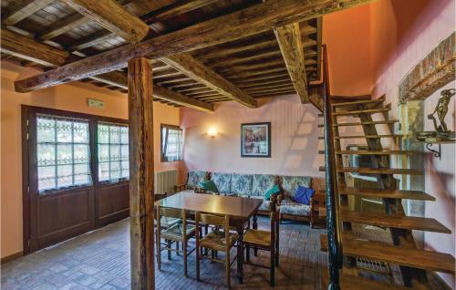 a dining room with a table and a spiral staircase at Villa Grimani in Il Rastello