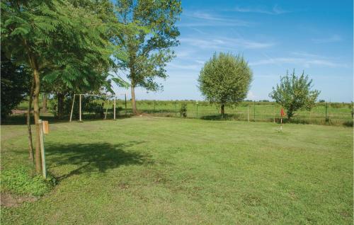 a large grass field with trees and a fence at Villa Grimani in Il Rastello