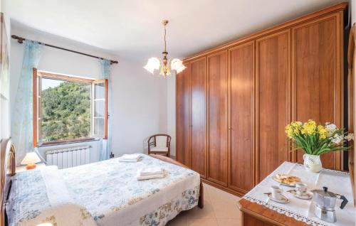 a bedroom with a bed and a table and a window at Casa Rosmarino in Chiesanuova
