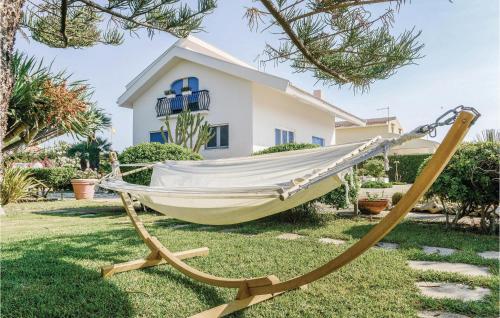 a hammock in a yard in front of a house at Villa Marina in Granelli