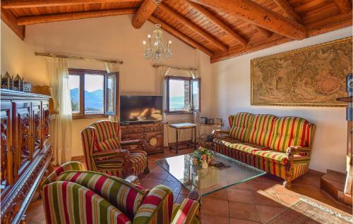 a living room with a couch and chairs and a tv at 2 Bedroom Stunning Home In Luino in Luino