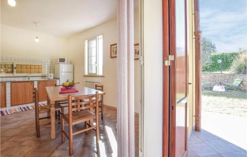 a kitchen with a wooden table and a dining room at Casa Sardina in Mandra Capreria