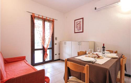 a dining room with a table and a refrigerator at Awesome Apartment In Costa Rei -Ca- With Wifi in Monte Nai