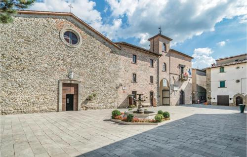 a large stone building with a fountain in a courtyard at Casellina in Apecchio