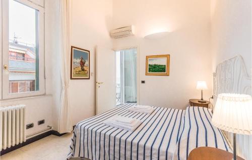 a white bedroom with a bed and a window at Tulipano in San Michele di Pagana