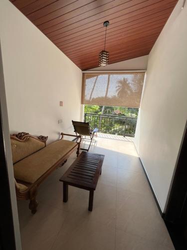 a living room with a couch and a window at Tanzanite place in Tangalle