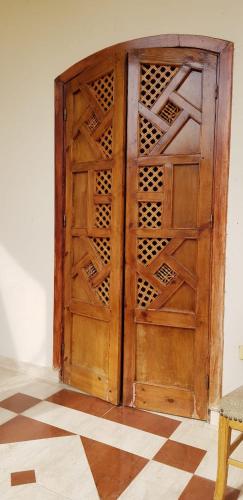 an open wooden door in the corner of a room at One Love Guesthouse & Restaurant in Luxor