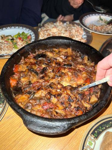 a pan of food sitting on top of a table at One Love Guesthouse & Restaurant in Luxor