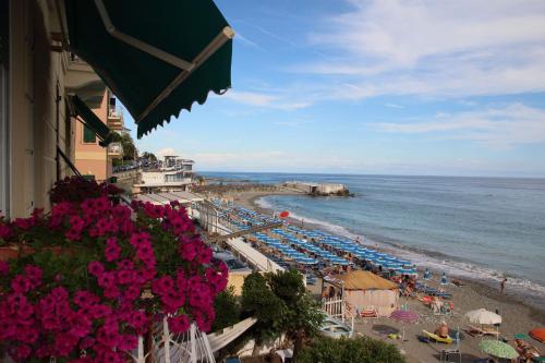 a beach with chairs and umbrellas and the ocean at B&B BnBeach in Varazze