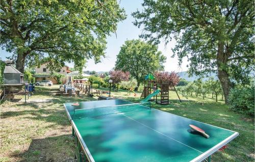 a ping pong table in a yard with a playground at Beautiful Home In Acquasparta -Tr- in Configni