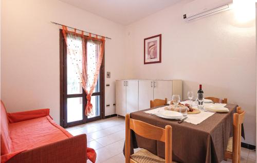 a dining room with a table and a kitchen at Lovely Apartment In Costa Rei -Ca- With Wifi in Monte Nai
