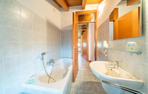 a bathroom with a tub and a sink at Macchia Rossa in Caprino Veronese