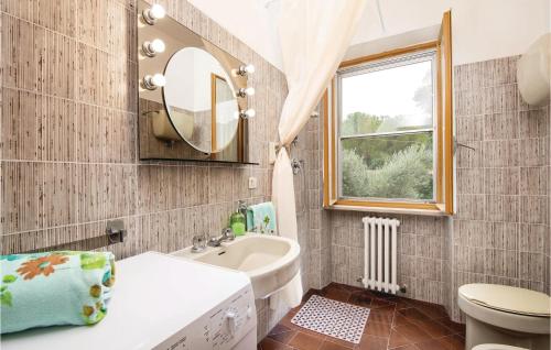a bathroom with a sink toilet and a mirror at Awesome Home In Spoleto -pg- With 3 Bedrooms And Wifi in Bazzano Inferiore