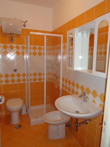 a bathroom with a toilet and a sink and a shower at Chiaia Apartments by Caseaponza it in Ponza