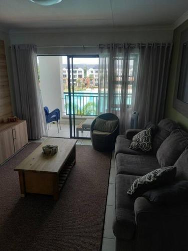 a living room with a couch and a coffee table at Breathtaking Lagoon View Apartment @ The Blyde1531 in Pretoria
