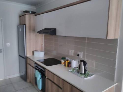 a kitchen with a sink and a stove top oven at Breathtaking Lagoon View Apartment @ The Blyde1531 in Pretoria