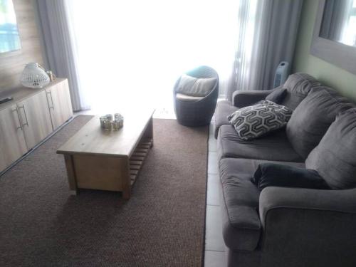 a living room with a couch and a coffee table at Breathtaking Lagoon View Apartment @ The Blyde1531 in Pretoria