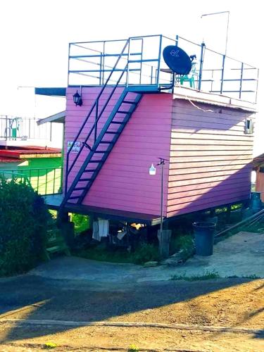 a building with a staircase on the side of it at ไร่รุ่งอรุณ ภูทับเบิก in Ban Maeo Thap Boek