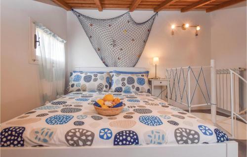 a bedroom with a bed with a bowl of fruit on it at Gorgeous Home In Imperia, Loc, Poggi in Poggi