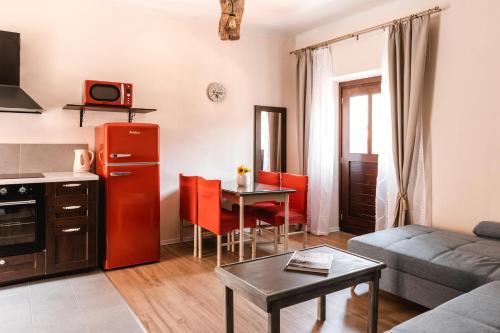 a living room with a red refrigerator and a table at Vila Ana in Štanjel