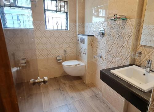 a bathroom with a toilet and a sink at Al Noor Palace in Bangalore