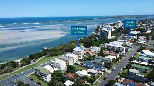 
a large body of water with a large building at Belvedere Apartments in Caloundra
